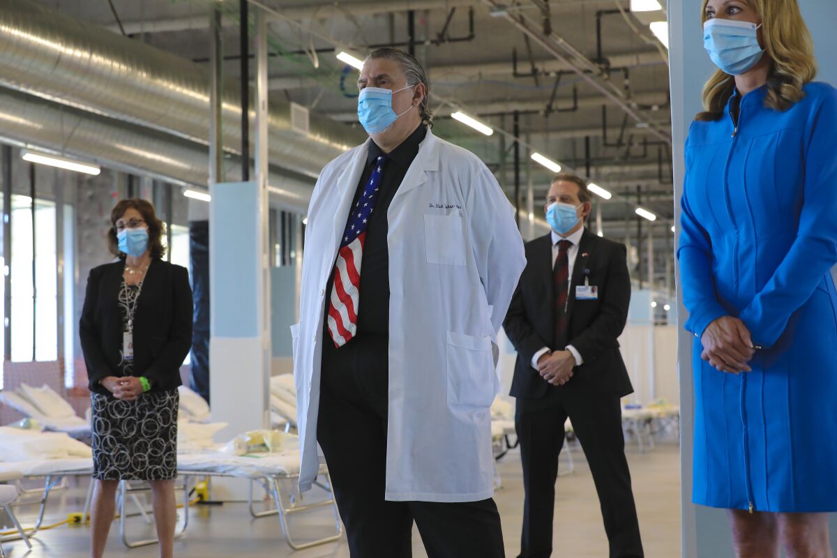 Dr. Nick Yphantides, San Diego County's chief medical officer, stands among other public officials at a press conference in April announcing the opening of the newly created federal medical station at Palomar Medical Center in Escondido.