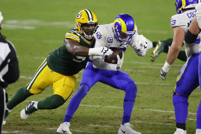 Green Bay Packers nose tackle Kenny Clark (97) sacks Los Angeles Rams quarterback Jared Goff (16) during an NFL divisional playoff football game between the Los Angeles Rams and Green Bay Packers, Saturday, Jan. 16, 2021, in Green Bay, Wis. (AP Photo/Jeffrey Phelps)