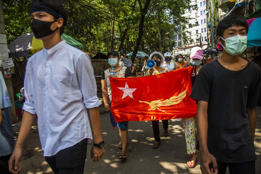 Protesters chant slogans and march in the street of Myaynigone township during the anti-coup demonstration in Yangon, Myanmar, Friday, April 9, 2021. An information blackout under Myanmar's military junta worsened Thursday as fiber broadband service, the last legal way for ordinary people to access the internet, became intermittently inaccessible on several networks. (AP Photo)