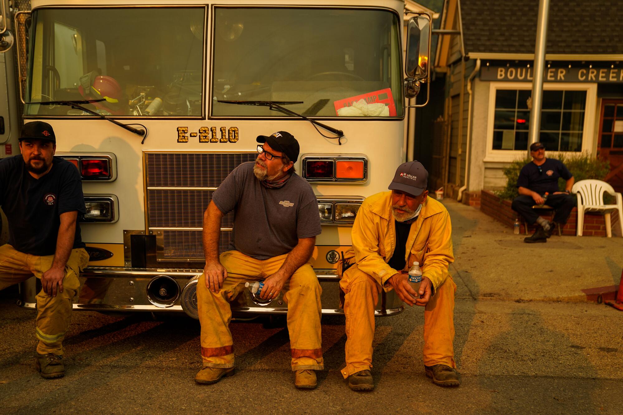 Boulder Creek firefighters take a break in front of the Boulder Creek Volunteer Fire Department firehouse