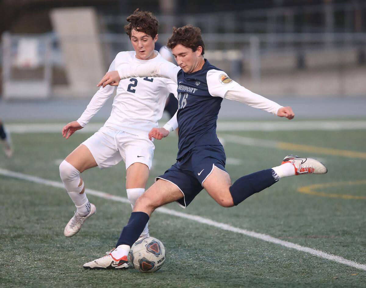 Newport Harbor's Jake Shubin (16) kicks in a goal as Loyola's Will Hoshek looks on Friday.