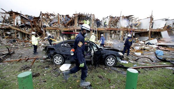 Firefighters search an apartment destroyed by an explosion at a fertilizer plant in West, Texas.