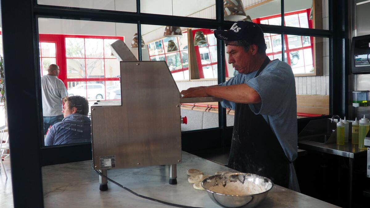 A Bäcoshop employee prepares dough for the bäcos, the flatbreads used to make sandwiches and wraps at the new Culver City restaurant.