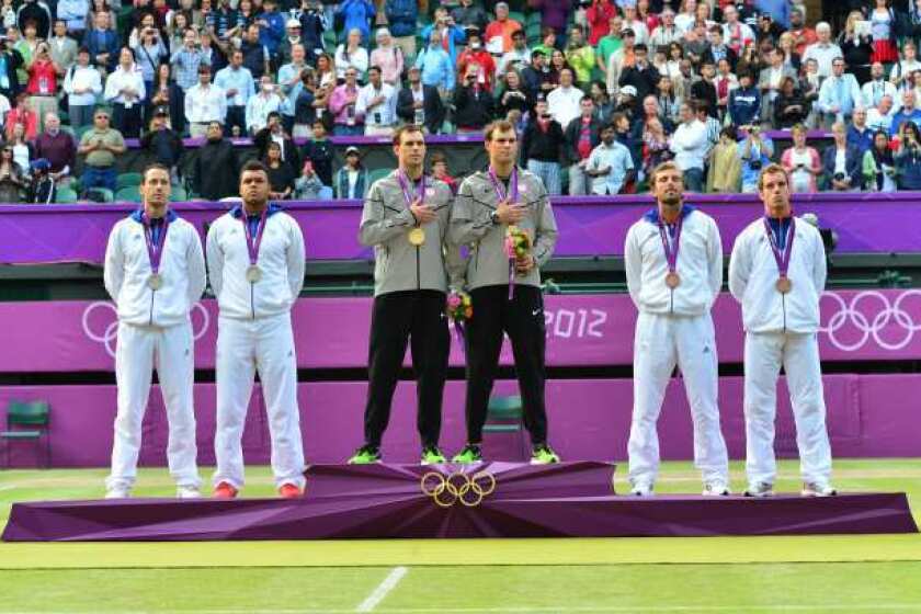 Bob and Mike Bryan, center, on the victory stand after winning the gold medal.