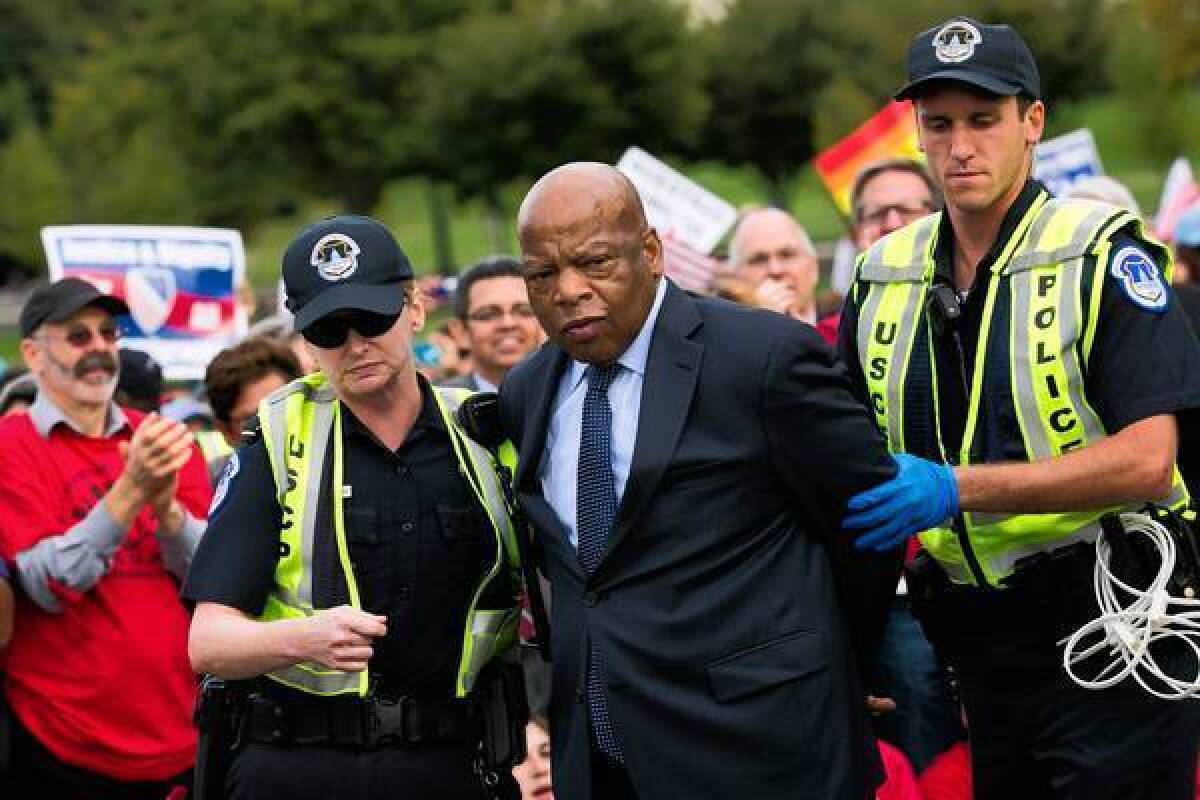 U.S. Rep. John Lewis (D-Ga.) is arrested outside the Capitol in Washington during a demonstration calling for the House to take up immigration overhaul legislation.