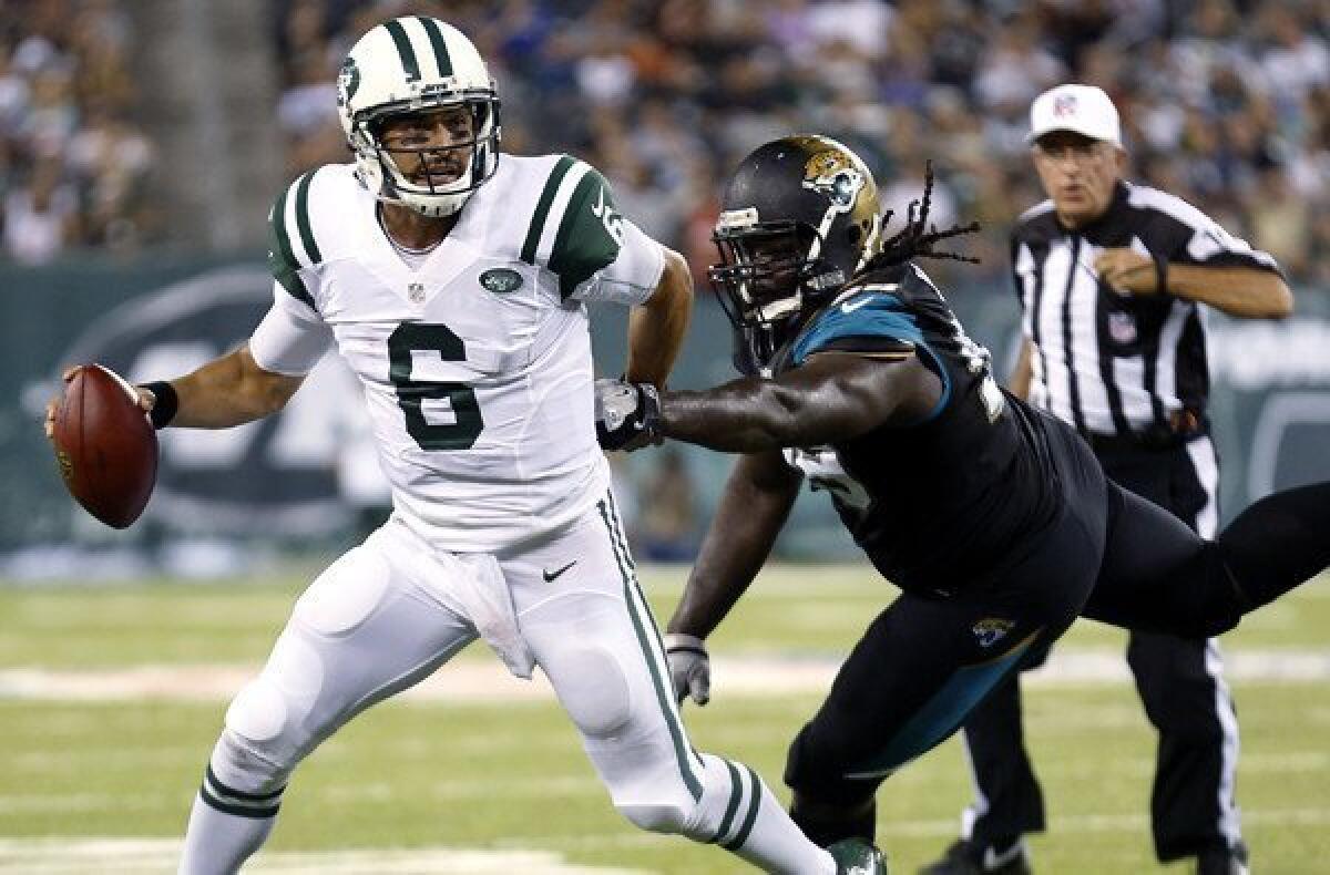 Jets quarterback Mark Sanchez (6) tries to evade the rush of Jaguars defensive tackle Sen'Derrick Marks in the first half Saturday night.