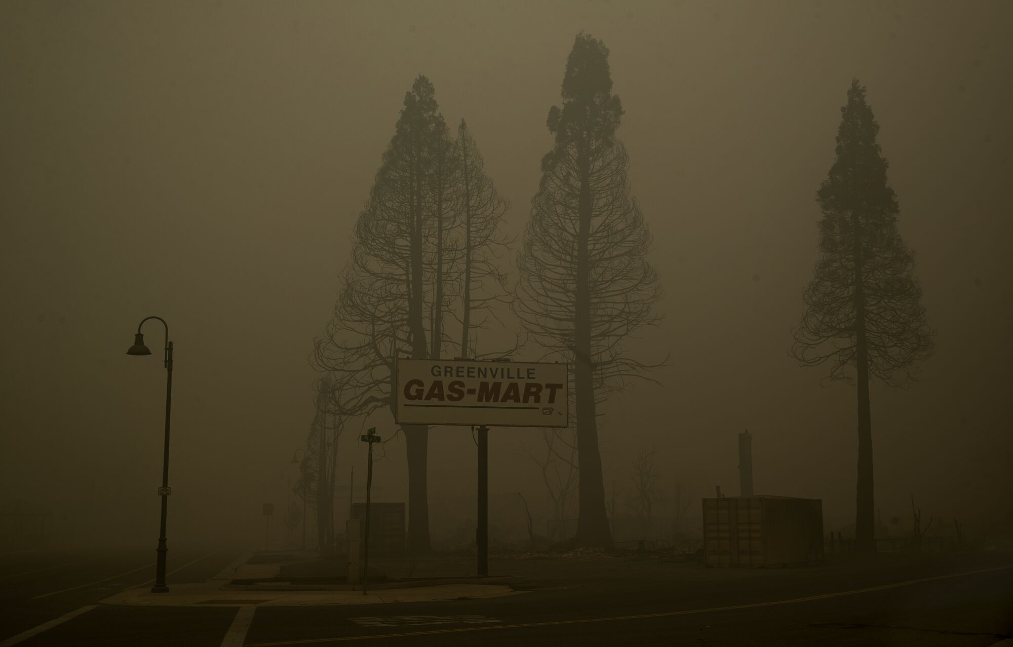 A 'Greenville Gas-Mart' sign is surrounded by thick smoke.
