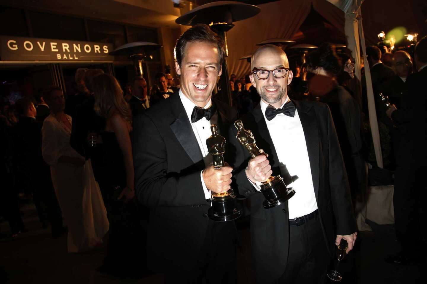 Nat Faxon, left, and Jim Rash hold their Oscars for best adapted screenplay for "The Descendants" outside the Governors Ball at the Hollywood & Highland complex.