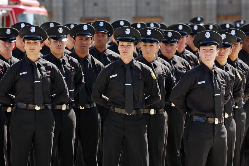 LOS ANGELES, CA - APRIL 28, 2016 - Firefighters Tiffany Scheidler, Chelsey Grigsby, and Kathryn Hersman, left to right in front row, are 3 of 5 females graduating as the Los Angeles Fire Department graduated 48 of its recruits at the Valley Recruit Training Academy on Thursday morning April 28, 2016. 5 of the 48 recruits were women which is tied for the record of most females graduating in one class. LAFD Chief Ralph M. Terrazas and first lady of Los Angeles, wife of Mayor Eric Garcetti, Amy Elaine Wakeland were among those who spoke during the commencement ceremony. (Al Seib / Los Angeles Times)