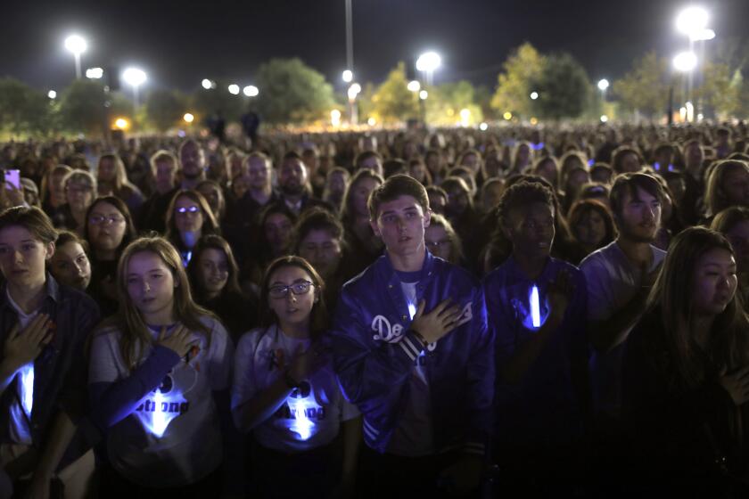 SANTA CLARITIA, CALIFORNIA—NOV. 17, 2019—Students say the Pledge of Allegience as thousands gather at Central Park in Santa Clarita to remember those killed (two plus the shooter) and wounded in the Saugus High School shooting on Nov. 17 2019. (Carolyn Cole/Los Angeles Times)