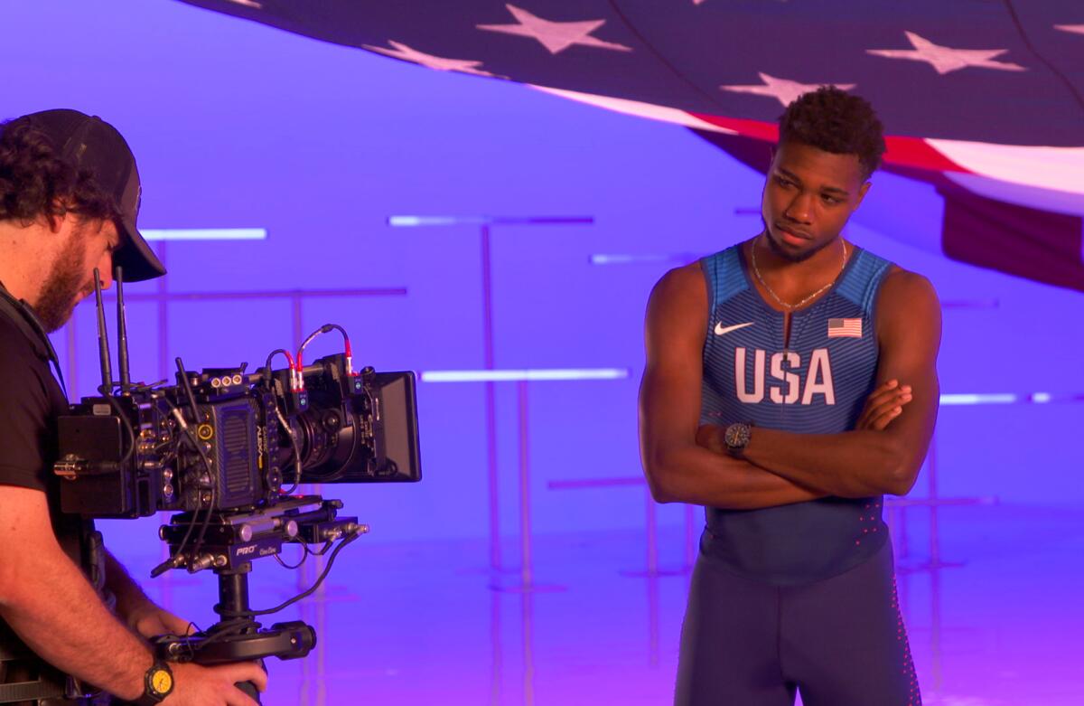 Noah Lyles on a "flag" soundstage. NBCUniversal recently summoned 110 U.S. athletes to a West Hollywood studio, shepherding them through soundstages, photo shoots and recording booths, taping interviews for use during the Games and, just as important, gathering raw material for ads and promos right now.