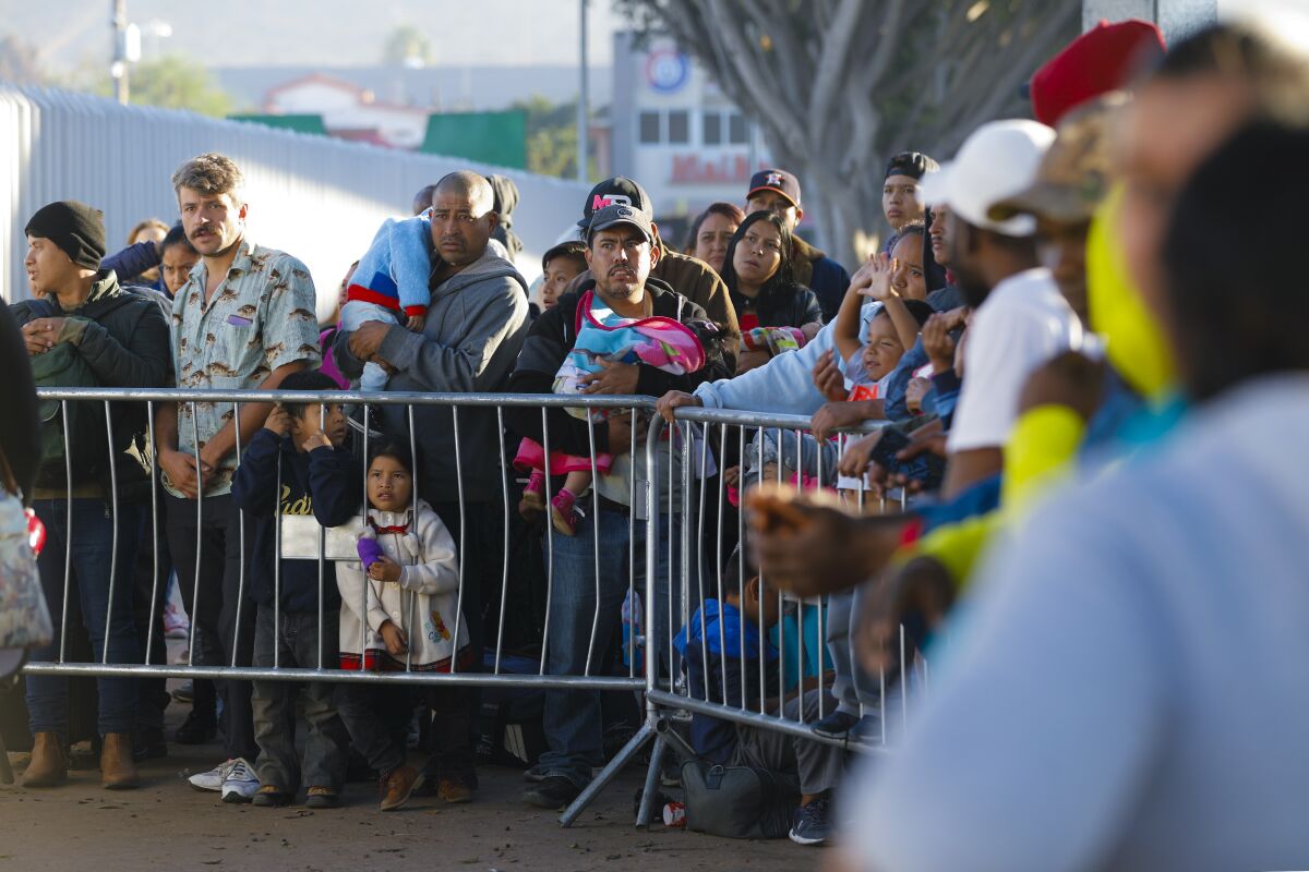 On Oct. 24, 2019, at the El Chaparral port of entry in Mexico, families wait hoping their number is called. A group of migrants gather everyday in the early morning hoping to begin the asylum application process to enter into the U.S.