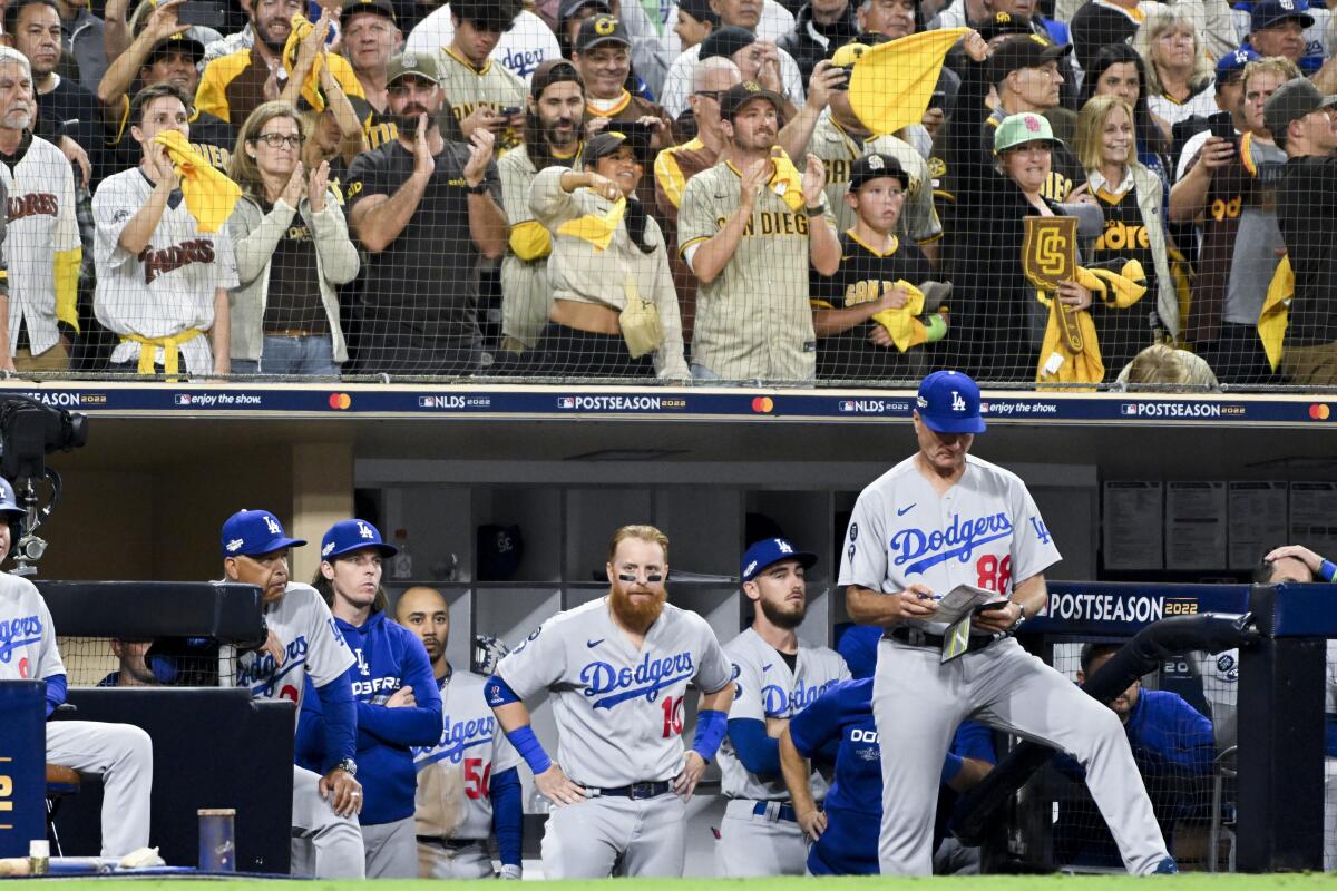 Dodgers players watch from the dugout during the ninth inning of a 2-1 loss to the San Diego Padres.