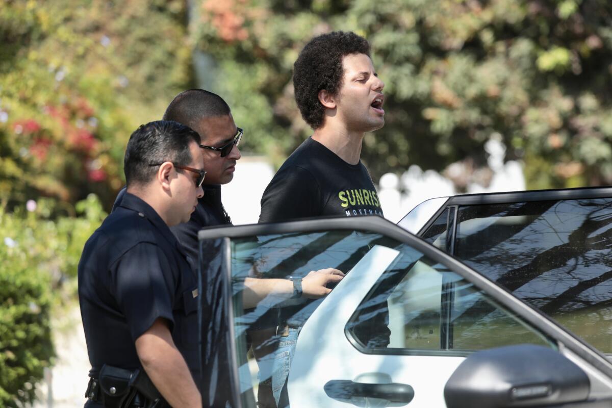 Los Angeles police officers arrest a protester outside Vice President Kamala Harris' home Monday.