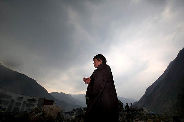 A Buddhist prays for the victims of the May 12, 2008, earthquake at the ruins of Beichuan County in China's Sichuan province. Many commemoration activities are being held to mark the first anniversary of the devastating quake that left nearly 90,000 people dead or missing.