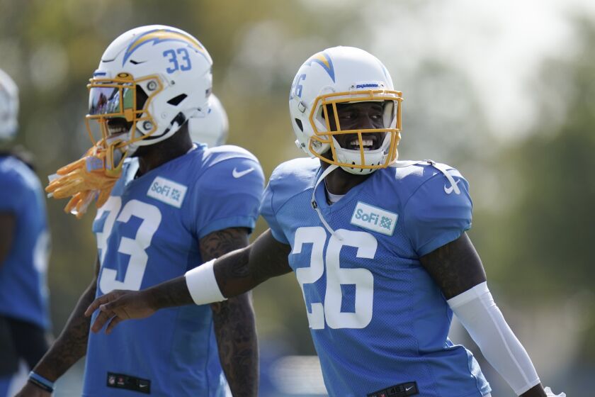 Los Angeles Chargers cornerback Casey Hayward Jr., right, and Derwin James warm up during an NFL football camp practice.