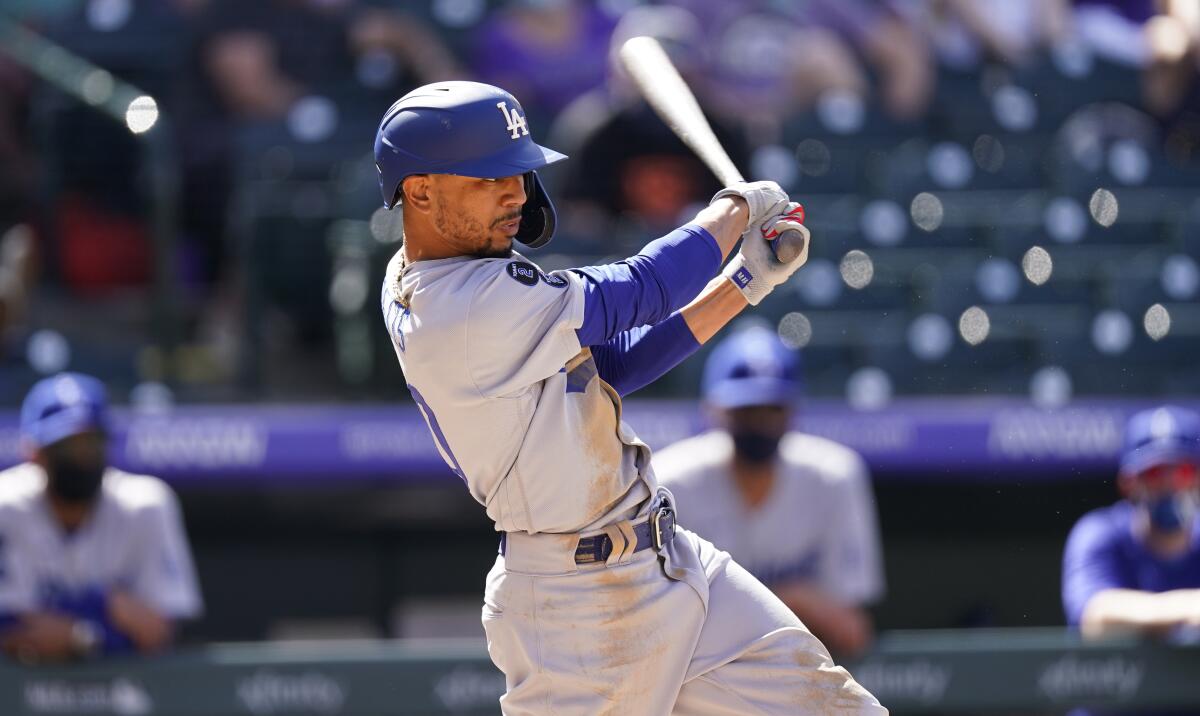 Dodgers right fielder Mookie Betts hits against the Colorado Rockies on April 4.