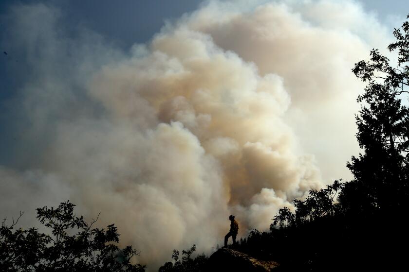 JANESVILLE, CALIF. - AUG. 189 2021. A huge plume of smoke billows skyward as the Dixie Fire burns through mountainous and forested terrain near Janesville on Thursday, Aug. 19, 2021. (Luis Sinco / Los Angeles Times)