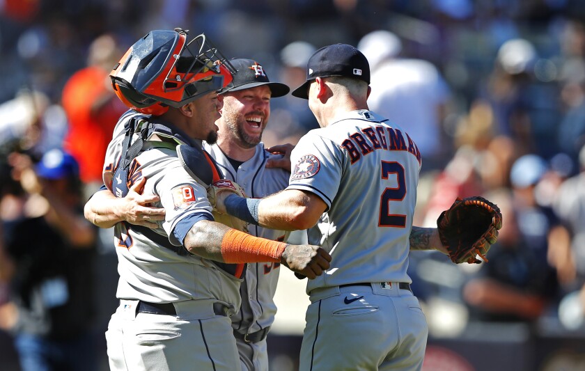 Houston Astros relief pitcher Ryan Pressly (55) celebrates with Martin Maldonado and Alex Bregman (2) after a combined no-hitter against the New York Yankees after a baseball game, Saturday, June 25, 2022, in New York. The Houston Astros won 3-0. (AP Photo/Noah K. Murray)