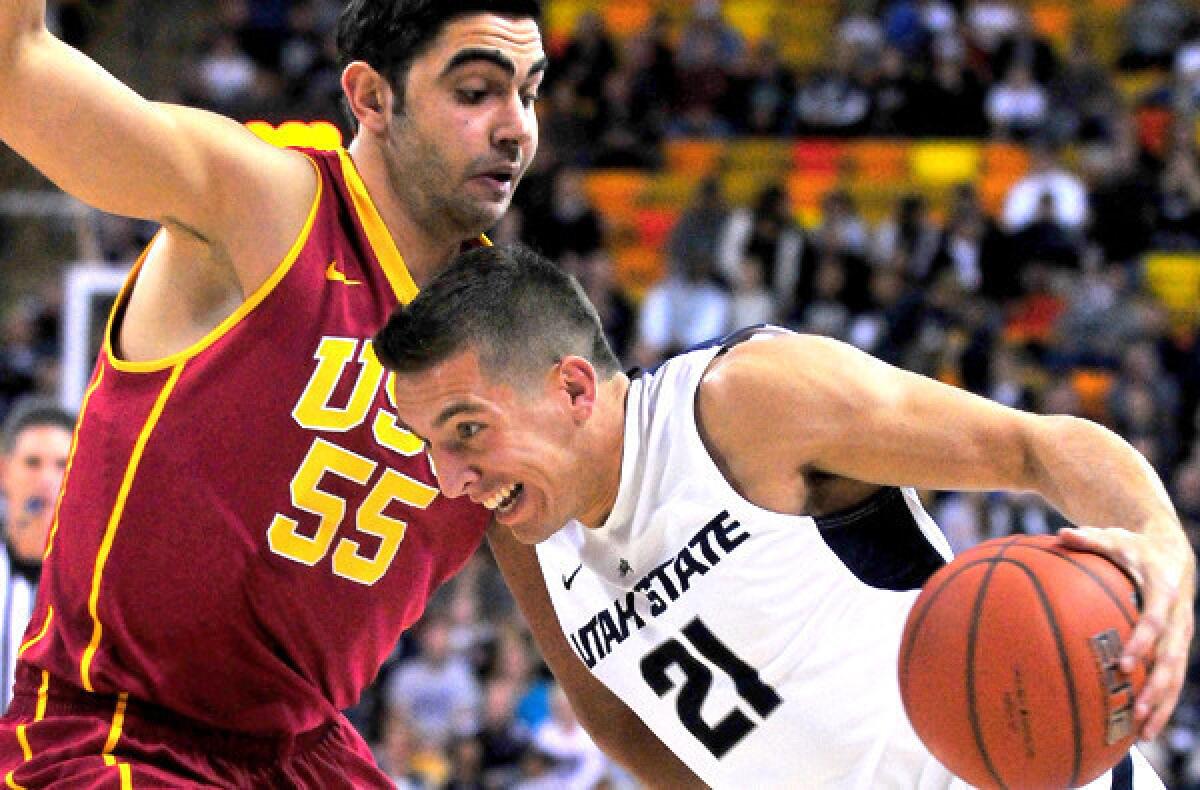 USC center Omzr Oraby tries to cut off a drive by Utah State's Spencer Butterfield during a game earlier this month,