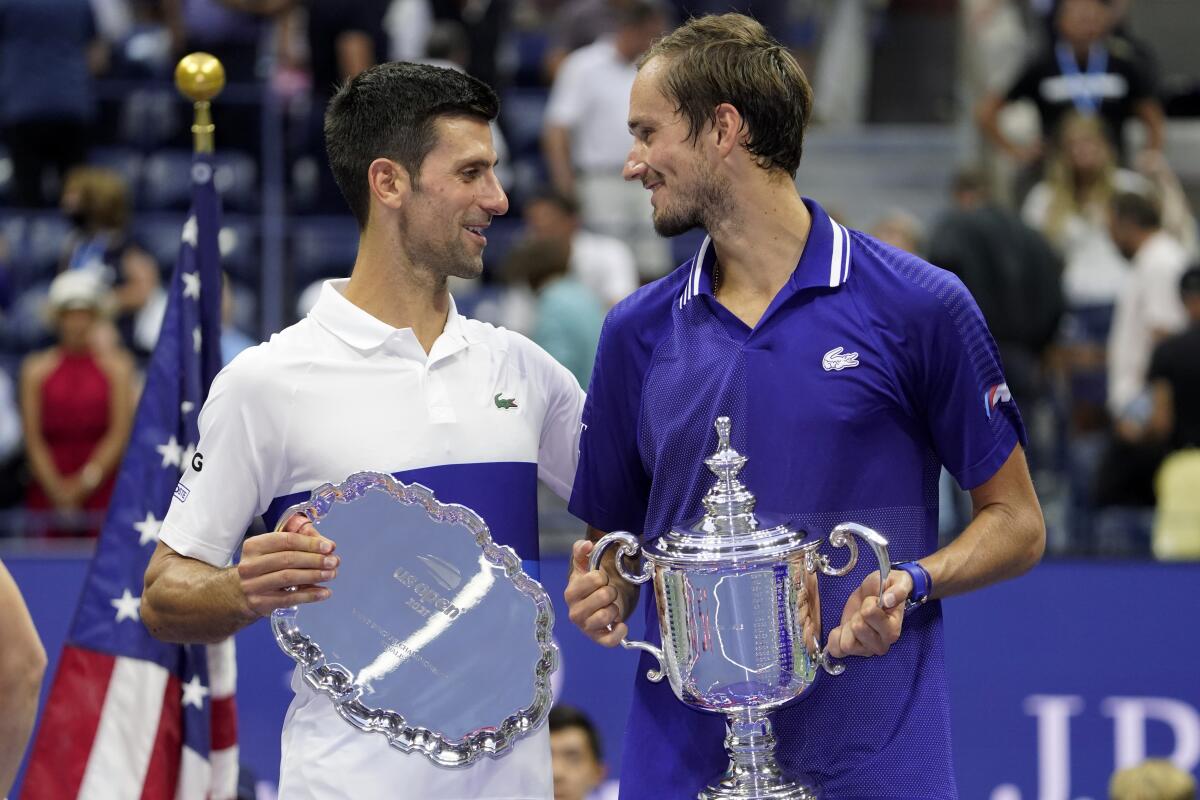 Novak Djokovic and Daniil Medvedev talk during the trophy ceremony.