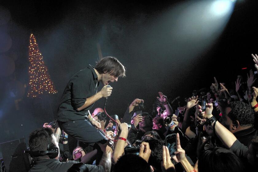 Thomas Mars of the band Phoenix at the Almost Acoustic Christmas show last month at Shrine Auditorium, where the crowd talked, texted and shot photos.