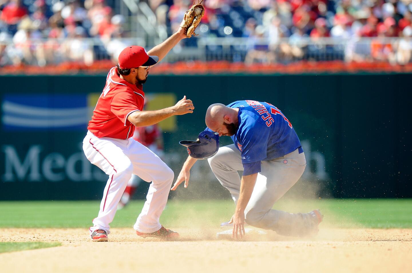 Nate Schierholtz steals second base in the eighth inning ahead of the tag of the Nationals' Anthony Rendon.