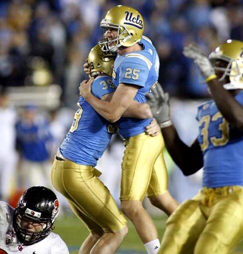 Bruins kicker Kai Forbath is congratulated by holder Danny Rees after making a 51-yard field goal as time expired Saturday to defeat the Oregon State Beavers, 17-14, at the Rose Bowl.