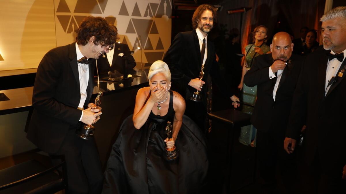 Winners for their "A Star Is Born" song "Shallow" Anthony Rossomando, left, Lady Gaga and Andrew Wyatt