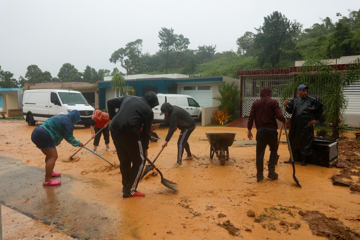 People use shovels to clean up mud.