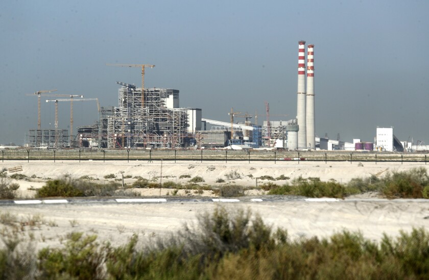 FILE - The coal-powered Hassyan power plant is seen under construction in Dubai, United Arab Emirates, on Oct. 14, 2020. The planned $3.4 billion coal-fired power plant in Dubai instead will be converted to use natural gas, the sheikhdom announced Thursday, Feb. 3, 2022, amid the United Arab Emirates' wider pledge to have net-zero carbon emissions by 2050. (AP Photo/Kamran Jebreili, File)