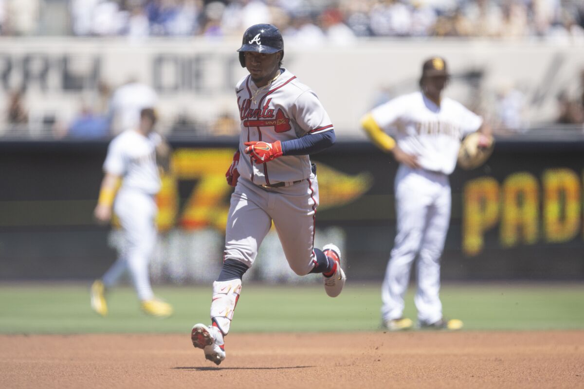 Ozzie Albies rounds the bases after hitting a solo home run during the first inning of Saturday's game against the Padres.