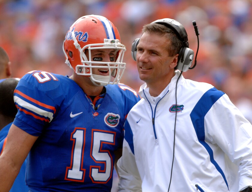 Florida quarterback Tim Tebow shares a laugh with coach Urban Meyer in 2008.