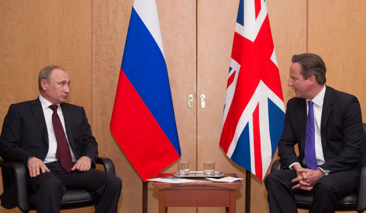 British Prime Minister David Cameron, right, and Russian President Vladimir Putin meet in Paris on Thursday, a day ahead of D-Day ceremonies in Normandy, France, that will bring together the U.S., Russian and European allies of World War II now divided over Ukraine.