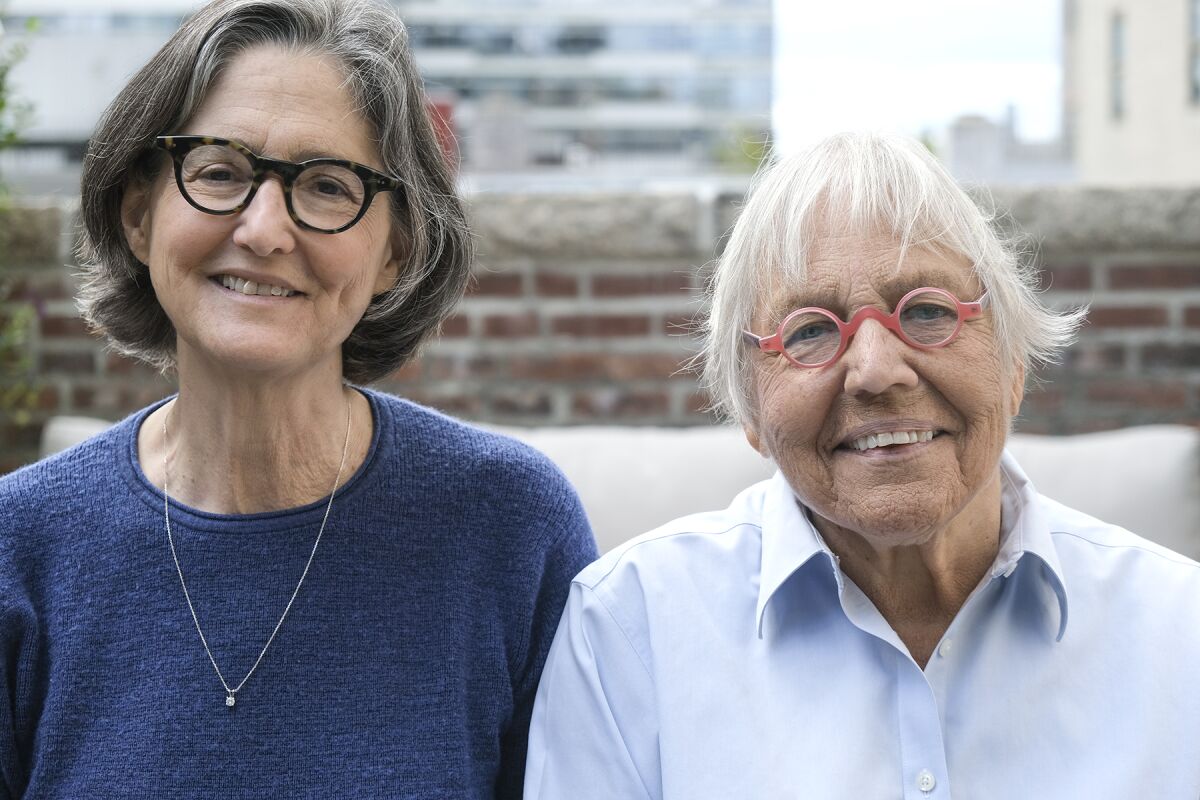 Two women in glasses looking at the camera