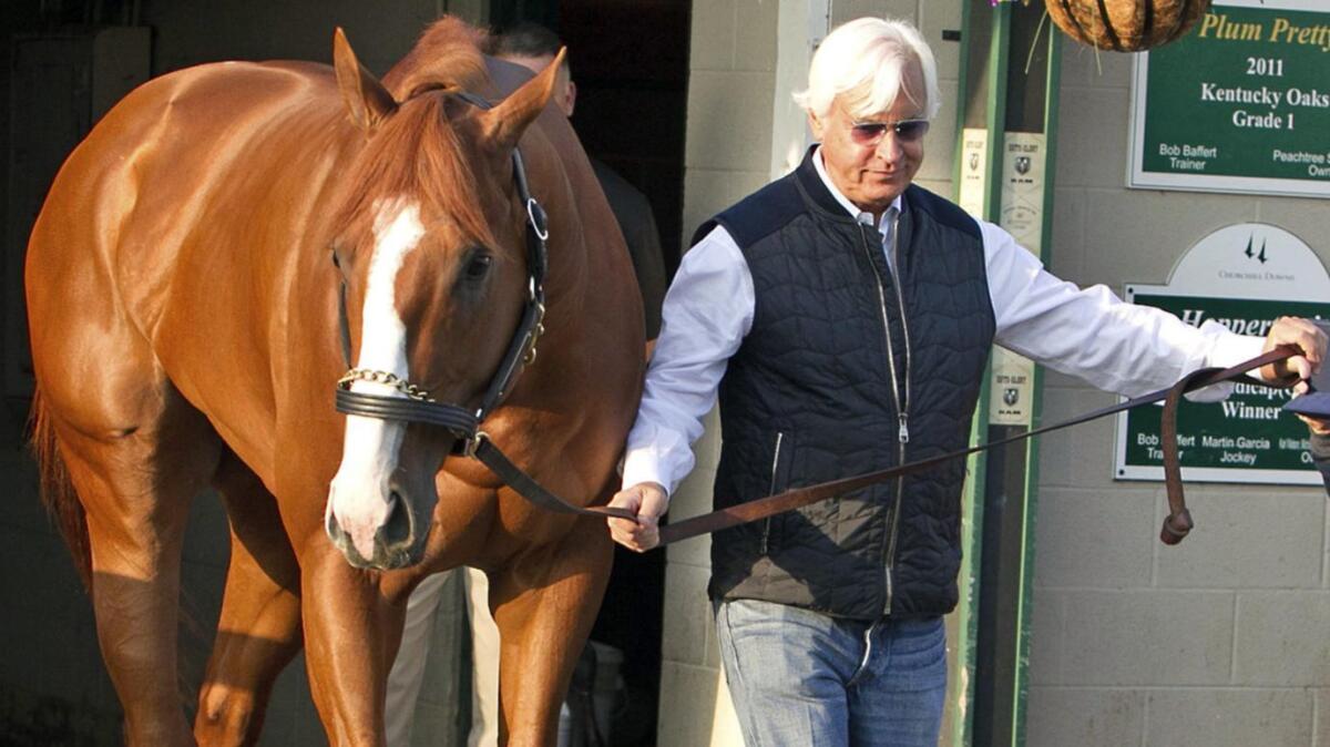 Bob Baffert leads Justify out of Barn 33 at Churchill Downs the morning after winning the Kentucky Derby.