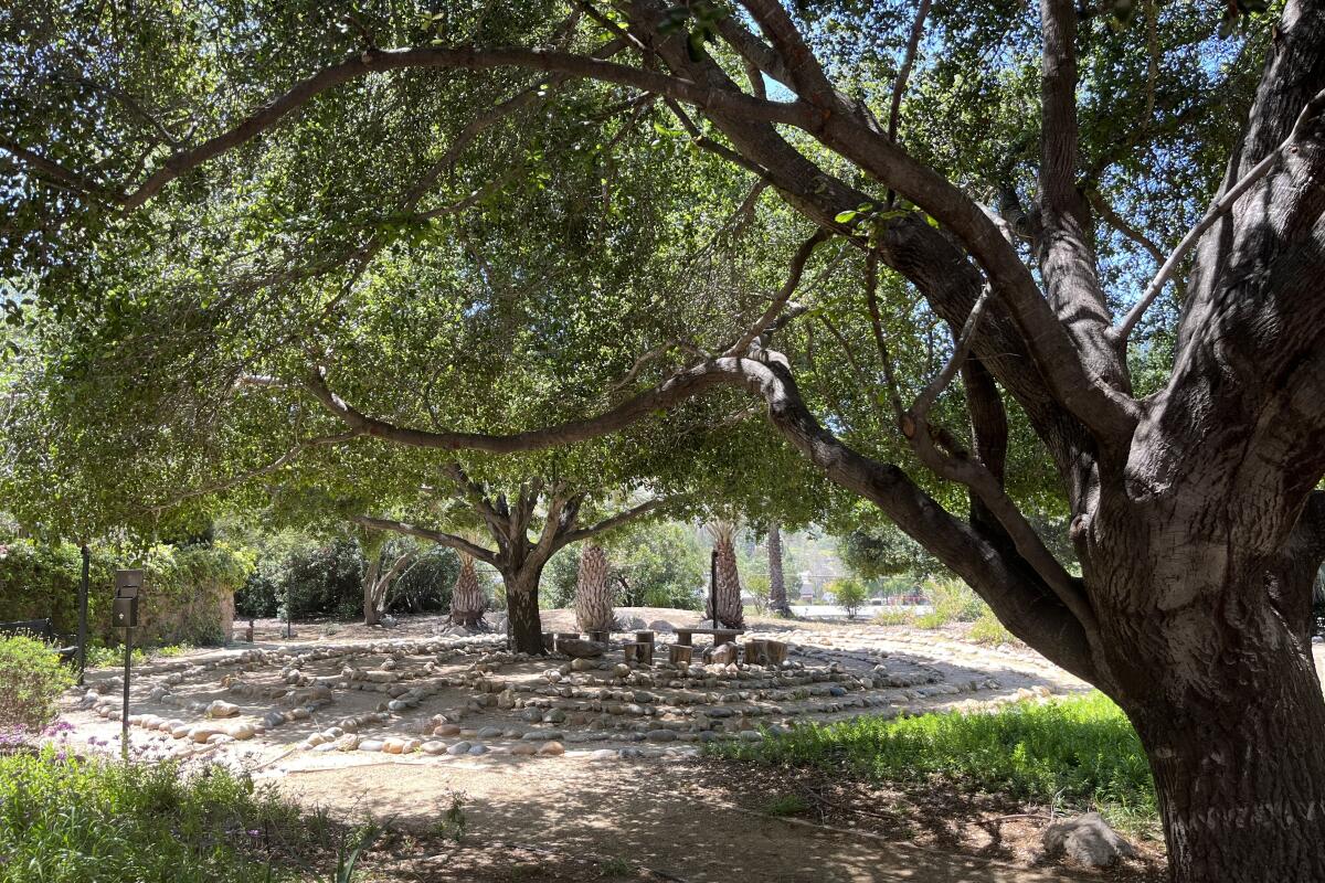 The St. Francis of Assisi Church Labyrinth is surrounded by large trees that offer shade.
