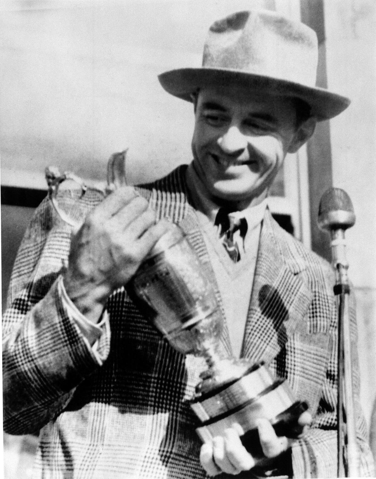 FILE - Sam Snead holds the British Open trophy he won, July 5, 1946, at St. Andrews, Scotland, with a 72-hole score of 290. He was the first American to win the trophy since 1933. (AP Photo, File)