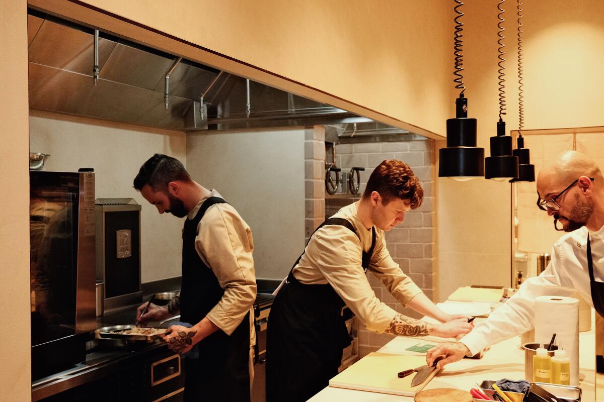 Zabala with two employees in the kitchen at Somni in West Hollywood.