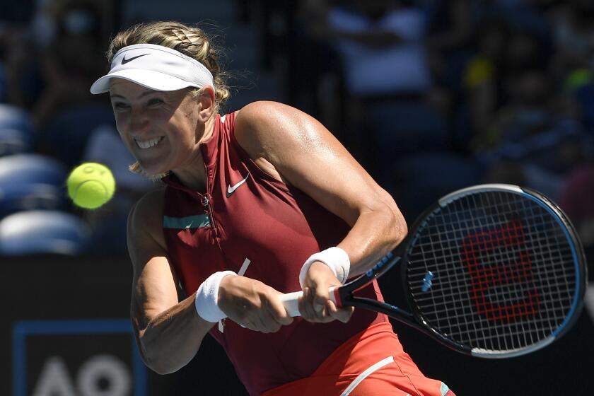 Victoria Azarenka of Belarus plays a backhand return to Elina Svitolina of Ukraine during their third round match at the Australian Open tennis championships in Melbourne, Australia, Friday, Jan. 21, 2022. (AP Photo/Andy Brownbill)