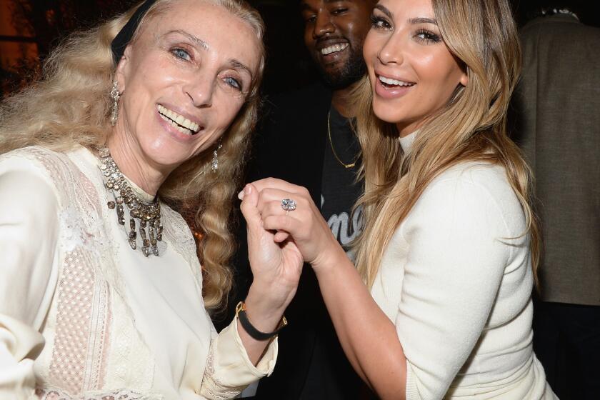 Honoree Franca Sozzani, left, holds Kim Kardashian's hand up to show off her new 15-carat engagement ring from Kanye West at the Dream for Future Africa Foundation Gala.