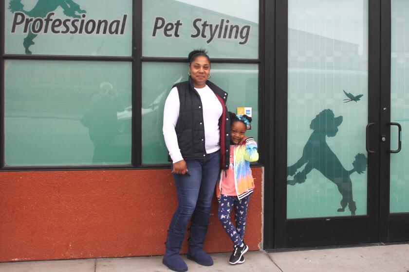 Lena Swann, owner of All About the Dogue grooming studio in Emeryville, with her daughter, Caliana.