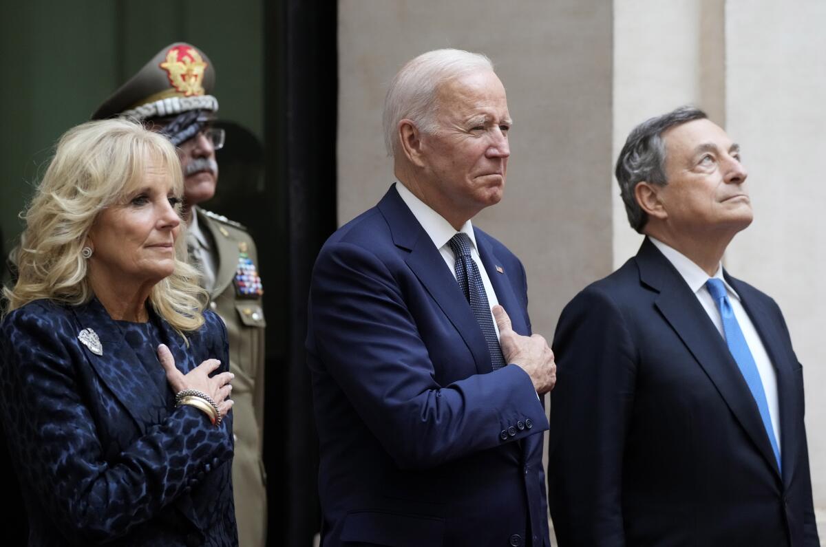 President Biden and First Lady Jill Biden stand with their hands on their hearts next to Italian Prime Minister Mario Draghi