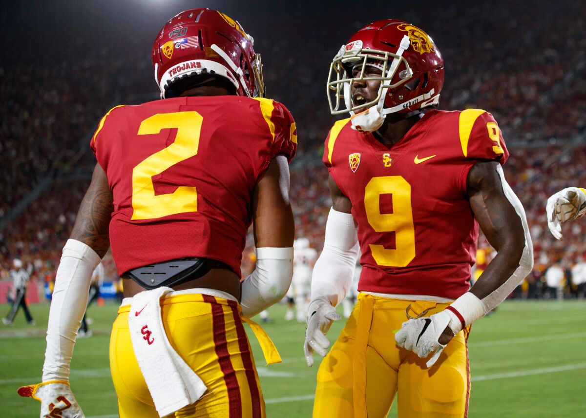 USC defenders Olaijah Griffin, left, and Greg Johnson.