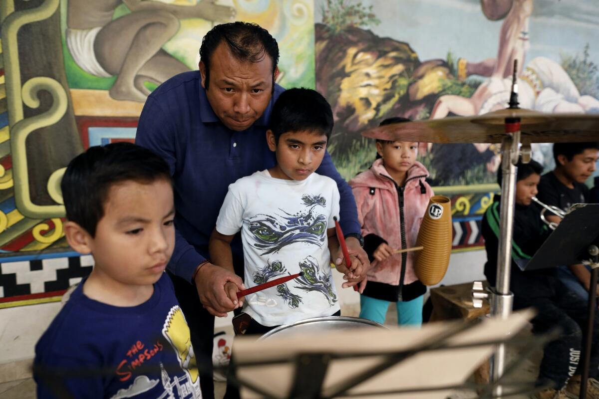 Alejandro Zamora gives percussion instructions to students in La Banda Sinfónica de Tlaxiaco at the Casa de la Cultura in Tlaxiaco. (Gary Coronado / Los Angeles Times) More Photos