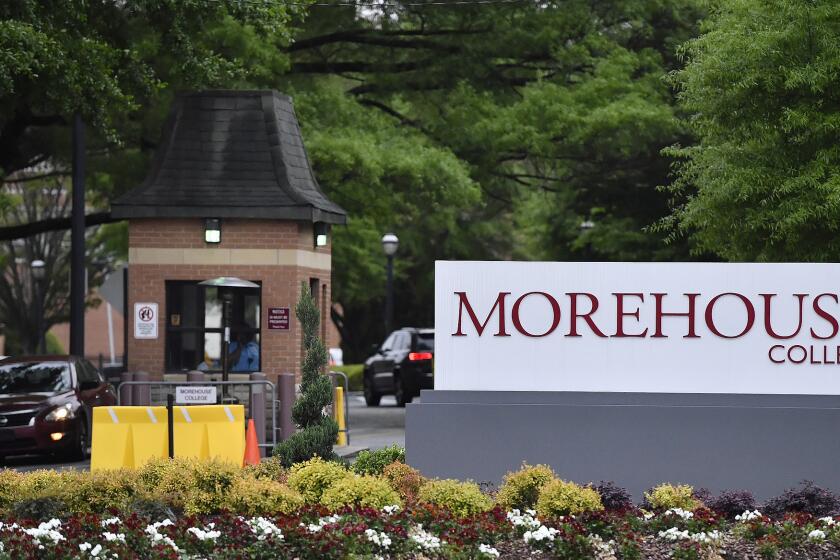 In this Friday, April 12, 2019 photo, people enter the campus of Morehouse College in Atlanta. The country's only all-male historically black college will begin admitting transgender men next year. The move marks a major shift for Morehouse College at a time when higher education institutions around the nation are adopting more welcoming policies toward LGBT students. Morehouse College leaders told The Associated Press that its board of trustees approved the policy Saturday. (AP Photo/Mike Stewart)