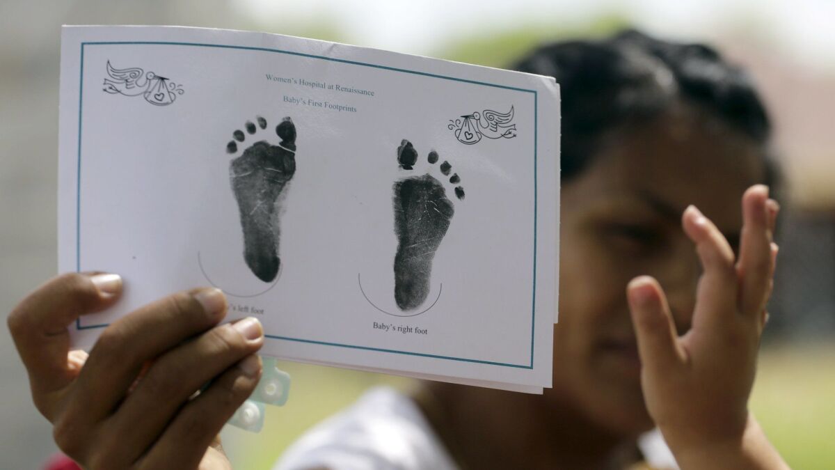 A woman in Sullivan City, Texas, who said she entered the country illegally, shows the footprints of her daughter, who was born in the United States, on Sept. 16, 2015.