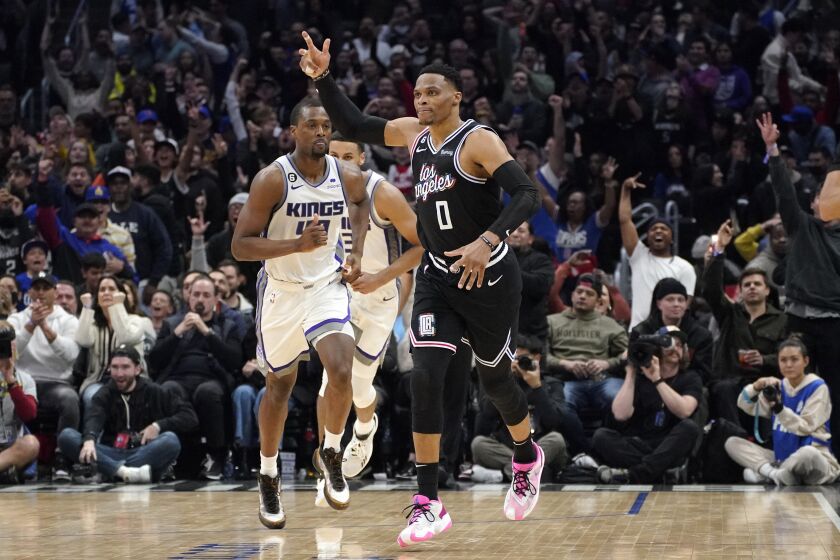 Los Angeles Clippers guard Russell Westbrook, right, celebrates after scoring as Sacramento Kings forward Harrison Barnes runs behind during the second half of an NBA basketball game Friday, Feb. 24, 2023, in Los Angeles. (AP Photo/Mark J. Terrill)