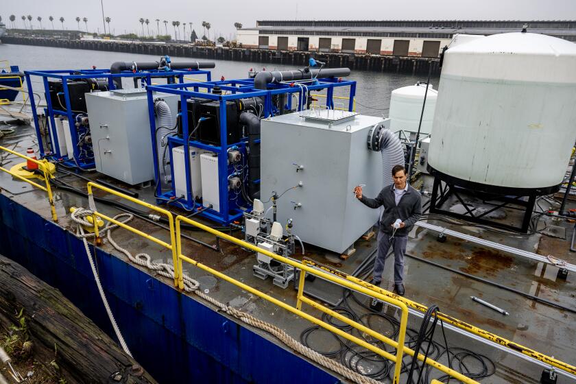 SAN PEDRO, CA -APRIL 12, 2023: Dante Simonetti, chemical and biomolecular associate professor, UCLA Samueli Associate Director, ICM, stands on the first of its kind scientific barge to demonstrate an electrochemical process for removing carbon dioxide from the ocean on April 12, 2023 in San Pedro, California. By removing carbon from ocean water, this technology could hypothetically help restore the ocean's ability to remove carbon dioxide from the atmosphere helping climate change.(Gina Ferazzi / Los Angeles Times)