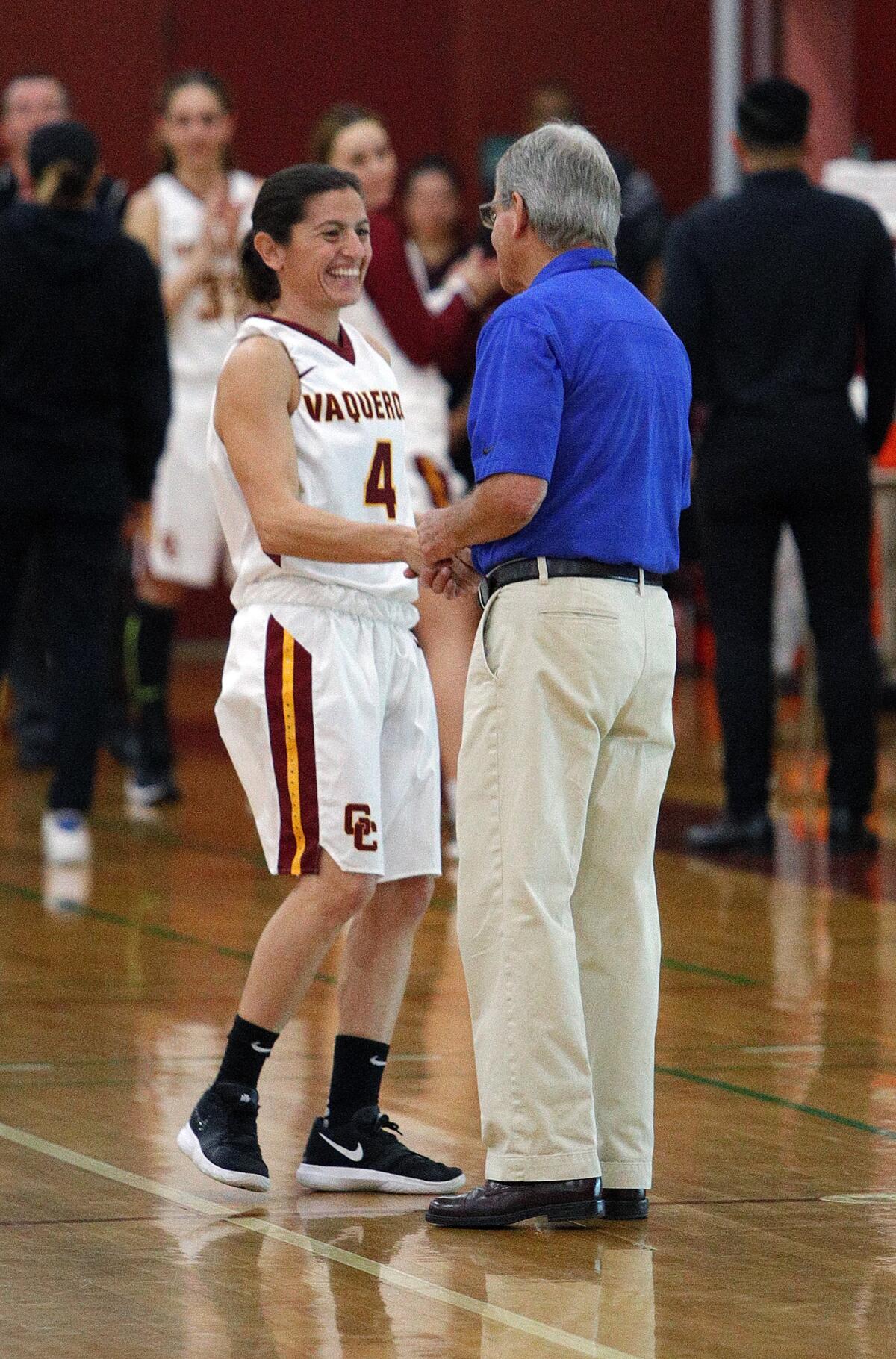 GCC's Vicky Oganyan shakes the hand of Allan Hancock's Cary Nerelli during introductions before a women's basketball game in the annual Vaquero basketball tournament at Glendale Community College on Wednesday, December 18, 2019. Oganyan is the long-time head coach of the Burroughs High School girls' basketball team and is playing for GCC while taking classes at GCC. Glendale won the game to improve to 10-1 on the season by defeating Allan Hancock 58-50.
